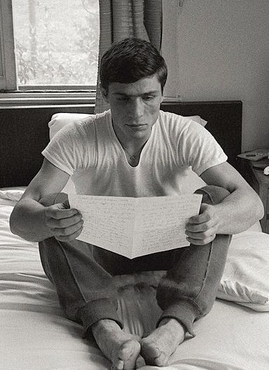 Fernando Atzori seduto a gambe incrociate mentre legge un giornale, alle Olimpiadi di Tokyo 1964